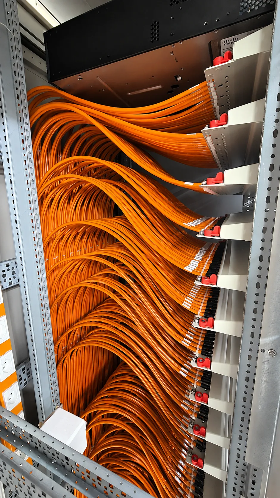 Orange UKV-Datenverkabelung im Netzwerkschrank, Swisstech Elektro